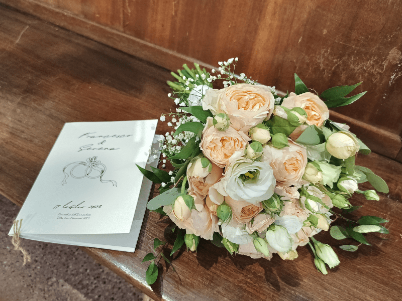 a bouquet of flowers on a bench